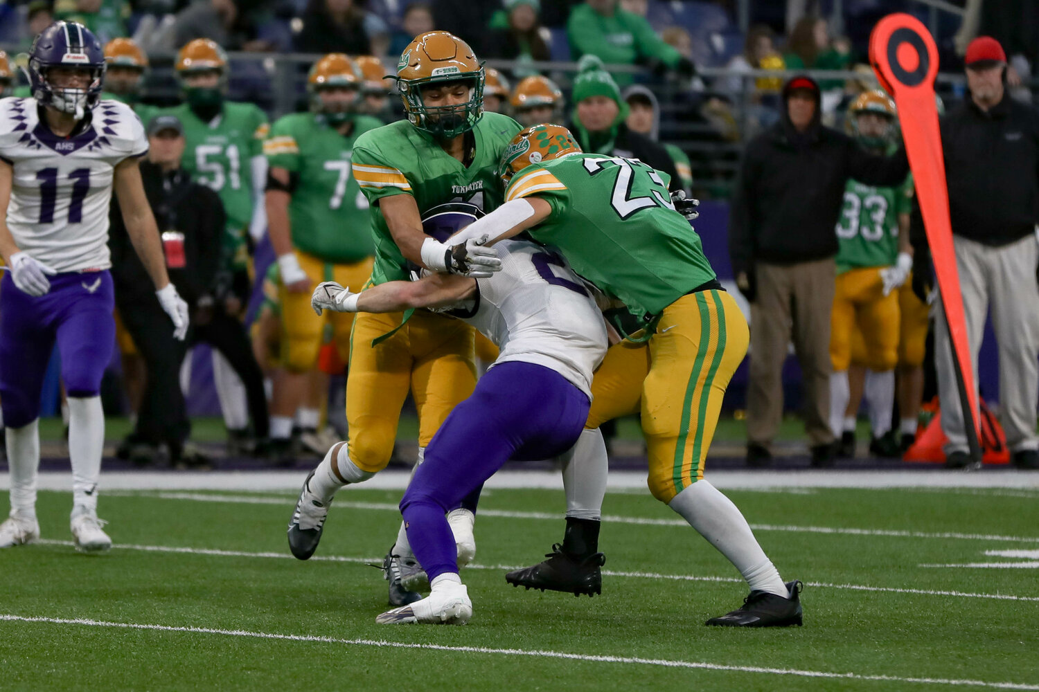 Tumwater defenders combine for a sack  during a 60-30 loss to Anacortes Dec. 2. at Husky Stadium.